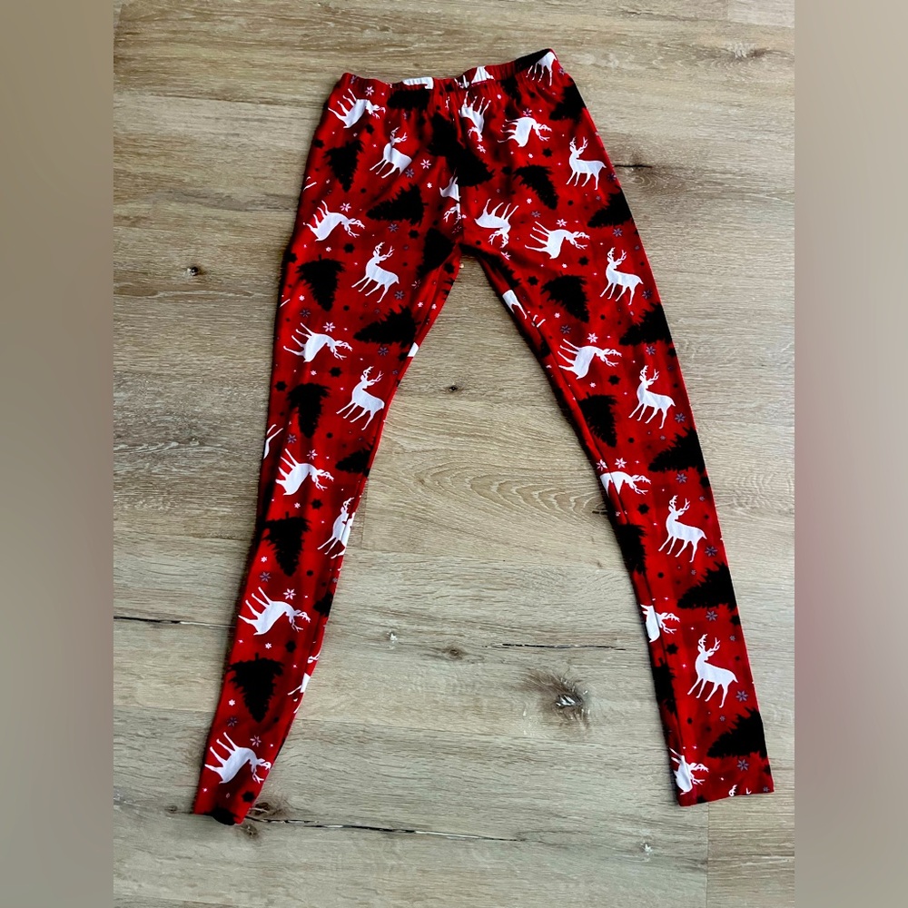 Silky soft Christmas leggings they have reindeer and Christmas trees on them.